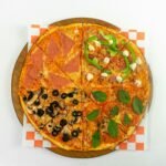 A pizza sitting on top of a wooden cutting board